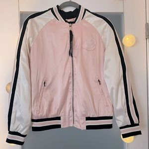 Satin pink bomber jacket with labels.